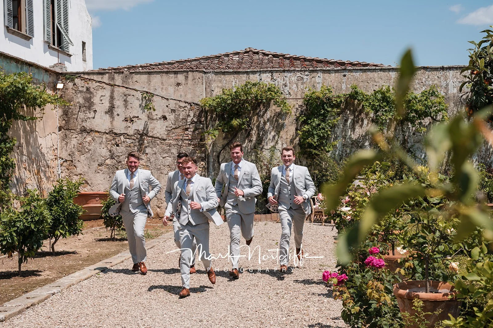 groomsman-party-running-to-ceremony-tuscany.jpg