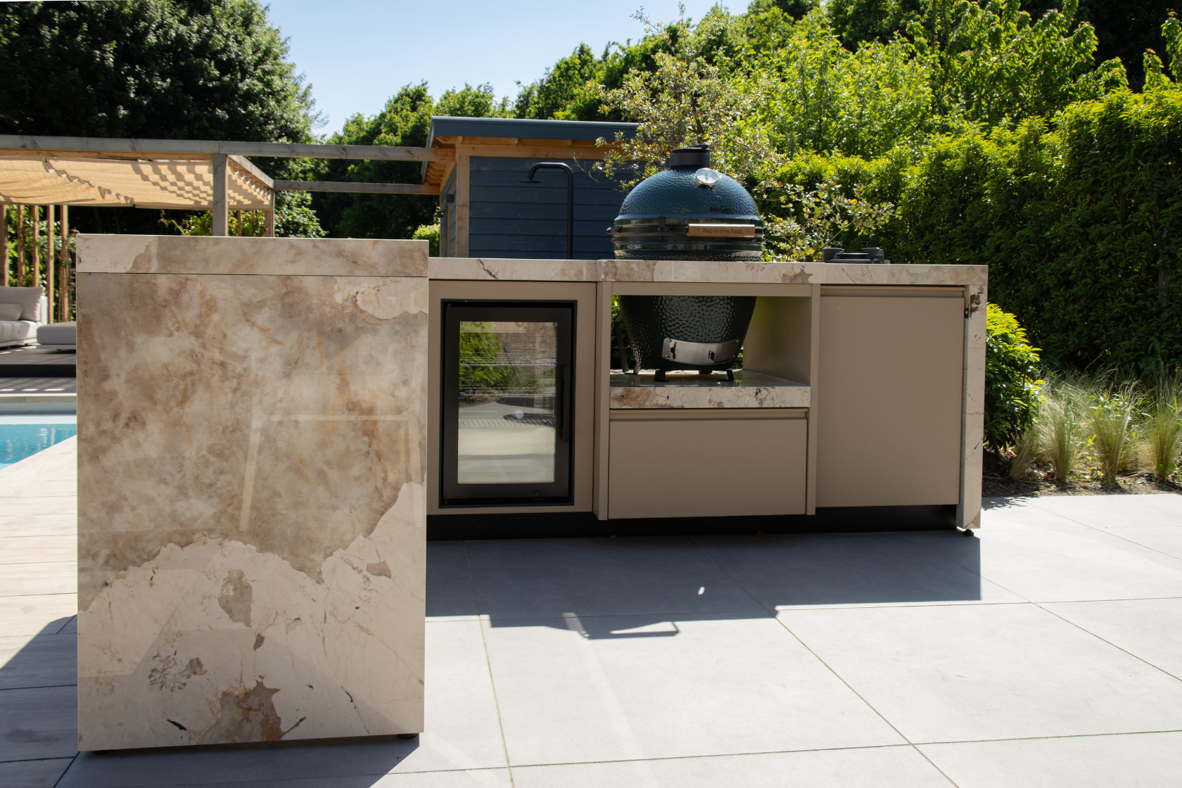 Zandkleurige luxe buitenkeuken met Big Green Egg en Koelkast