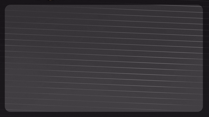 A notebook or writing pad with horizontal lines on a dark surface.