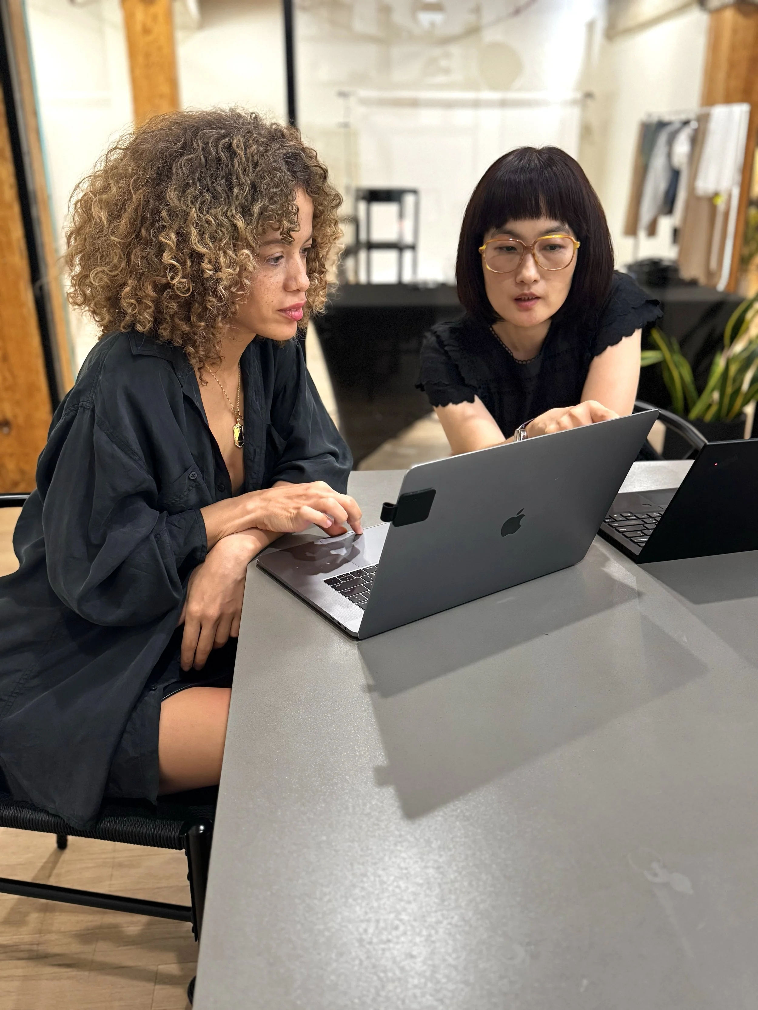 fashion product developers having a meeting reviewing designs on a laptop