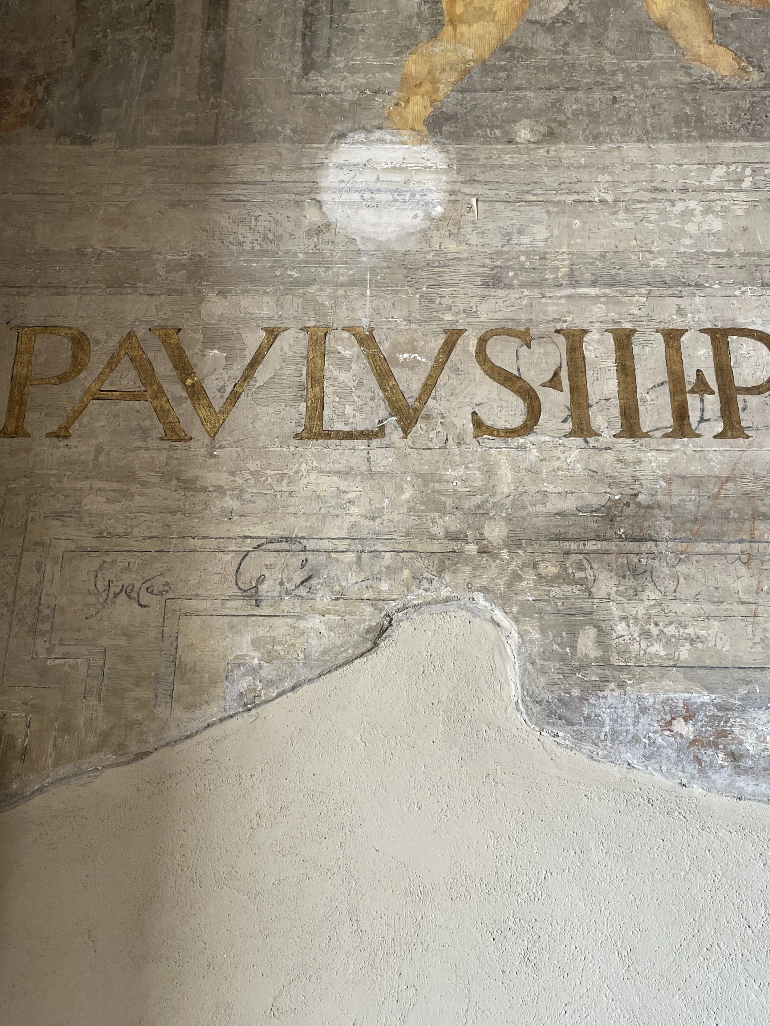 Old wooden floor with faded painted text that reads 'PAVL VSHIP' and some chalk markings.