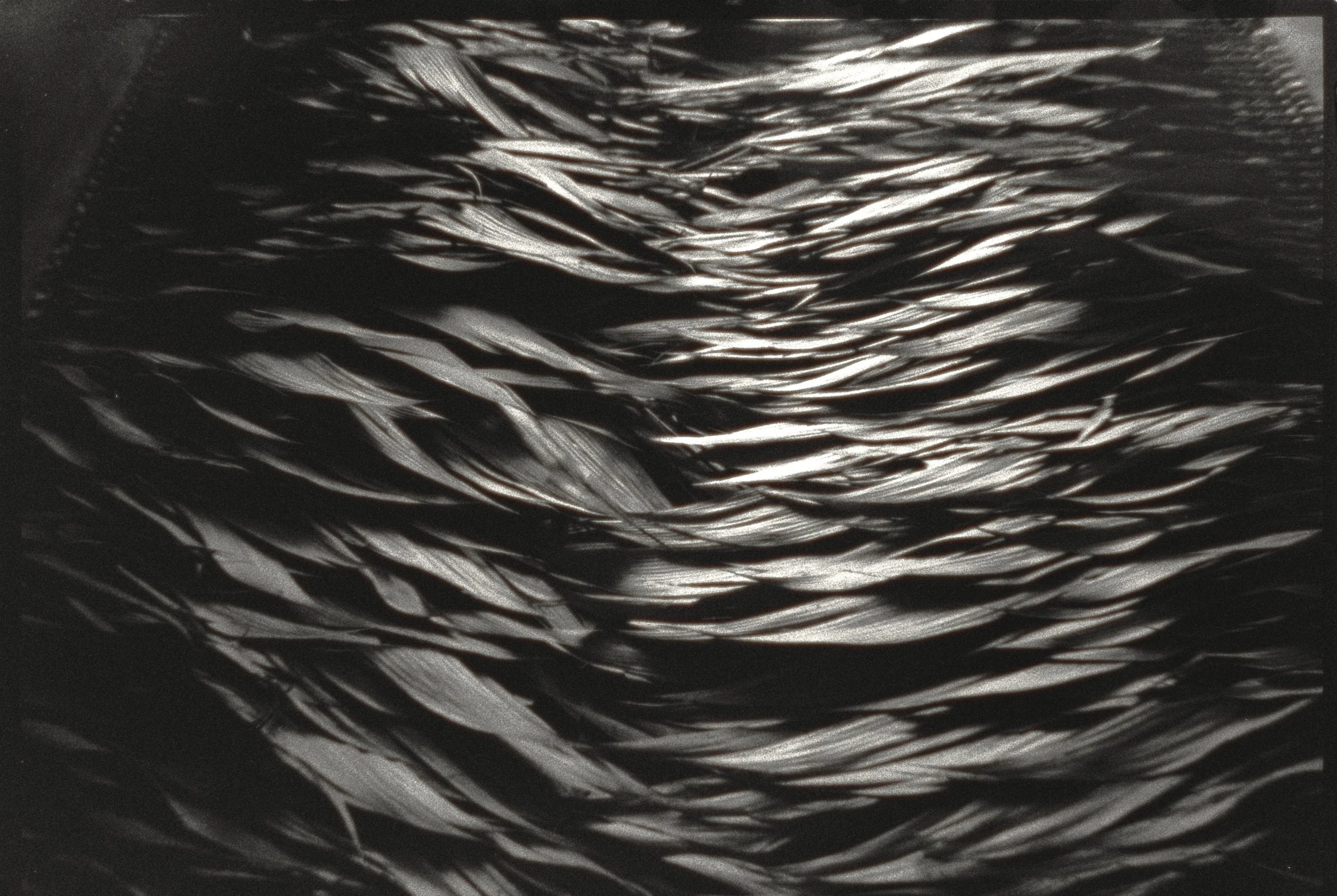 Close-up of metallic hair braid showing detailed strands and shiny texture.