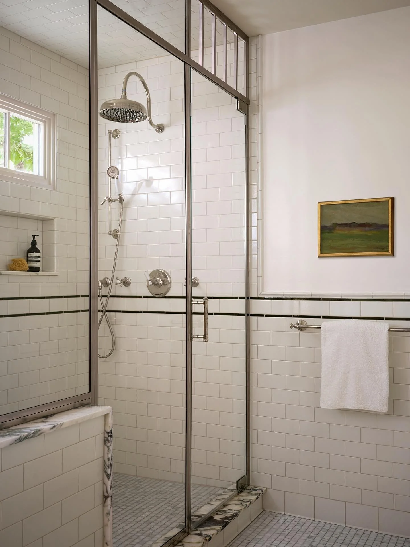 In our Hyde Park project, we came up with what we like to call a &ldquo;poor man&rsquo;s steam shower.&rdquo; By running the custom stainless steel and glass enclosure all the way up to the ceiling and leaving the transom over the door open as a gril