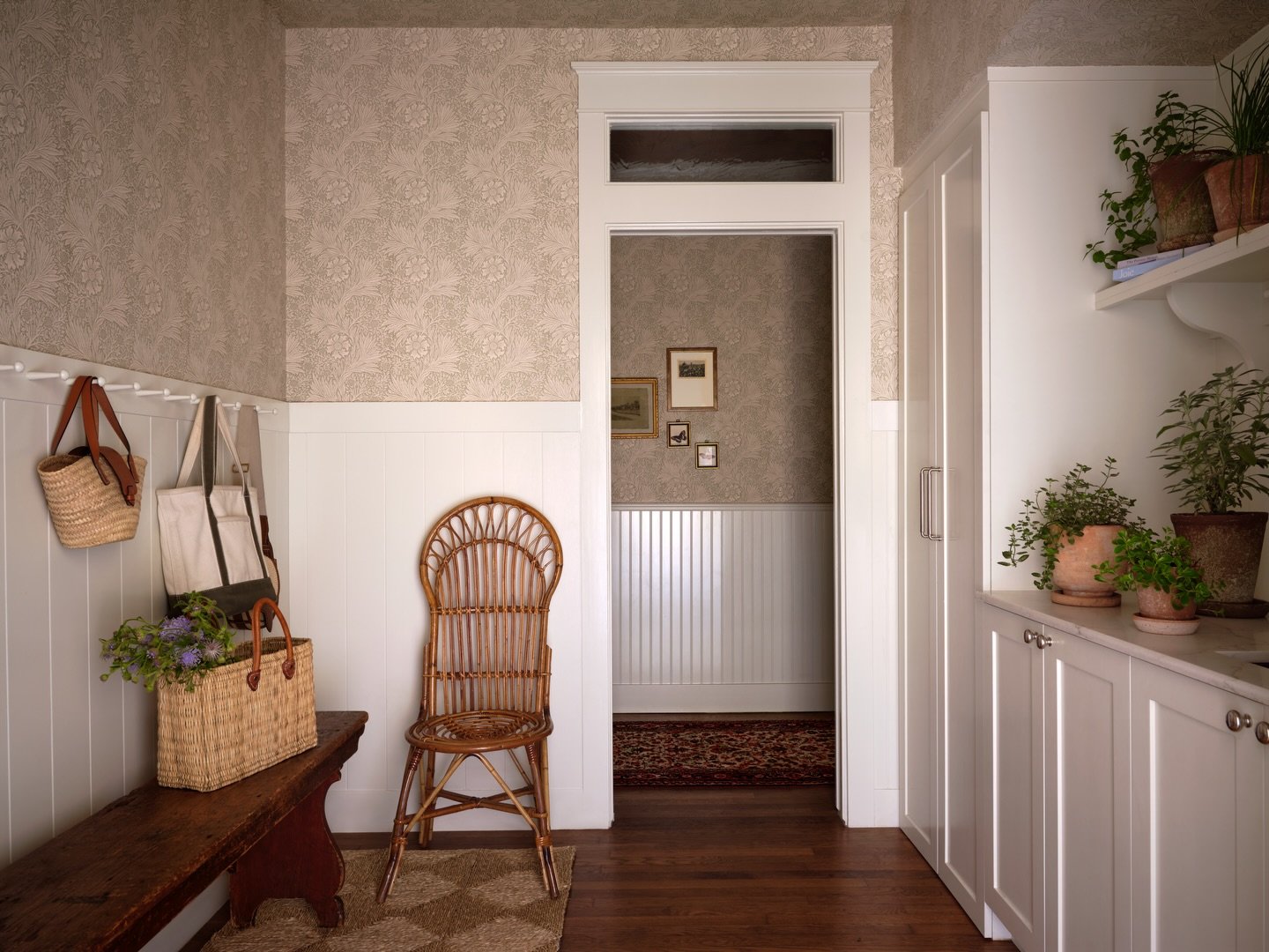 Would you guess that transom window above the doorway was added during the renovation?

This 1939 bungalow has one long central corridor with all the main rooms branching off of it, which meant the hallway originally felt a bit dark. Since the rooms 