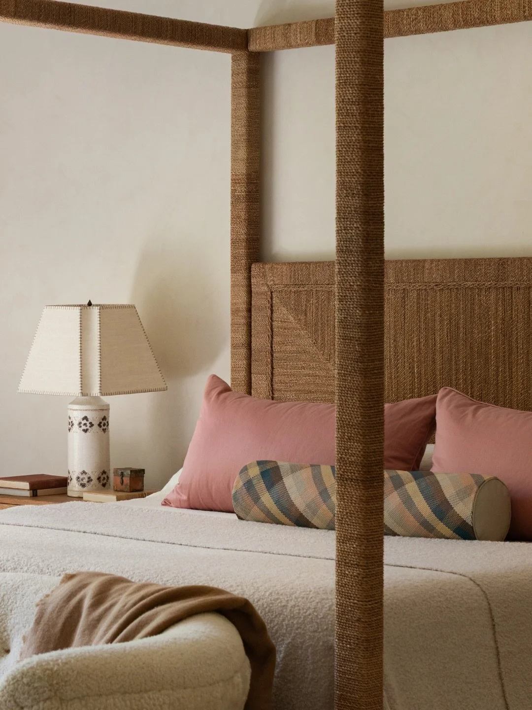 Would you have guessed the splurge moment in this French Provincial bedroom was the accent pillow? 

This custom woven leather bolster pillow, designed in a plaid palette inspired by the South of France and the architecture of the home. Because leath