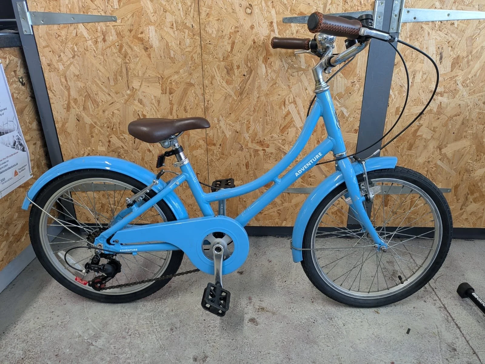 a photo of a blue refurbished children's bike 