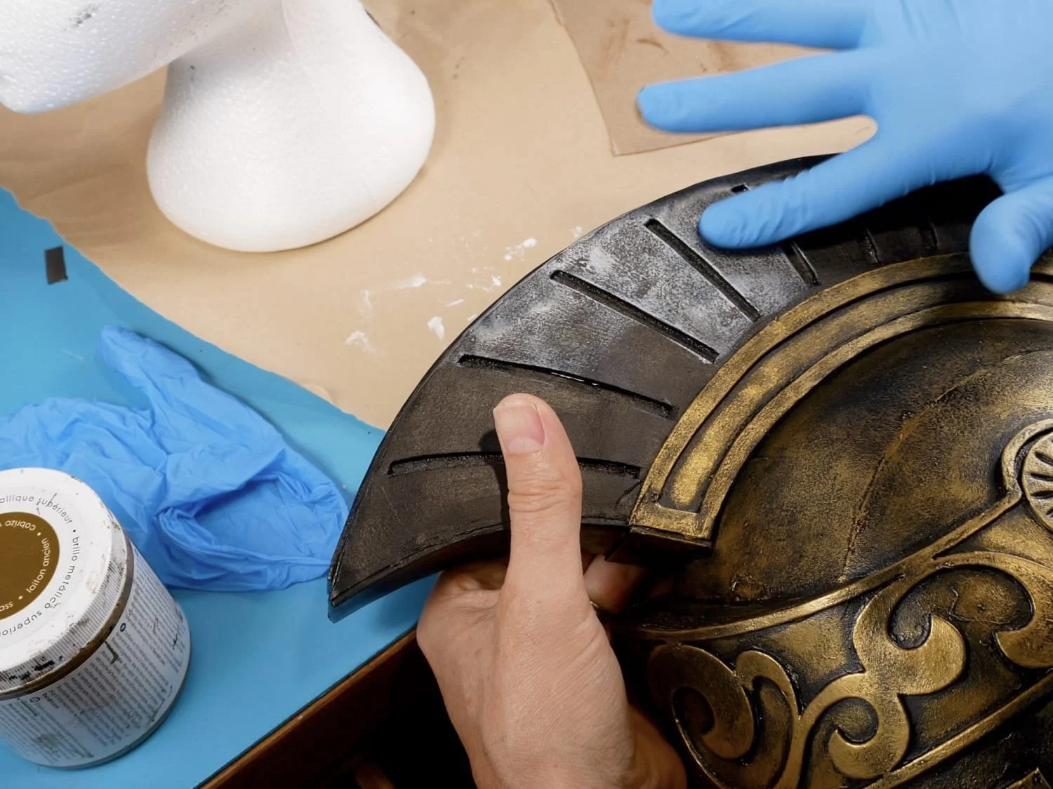 applying silver metallic paint to helmet