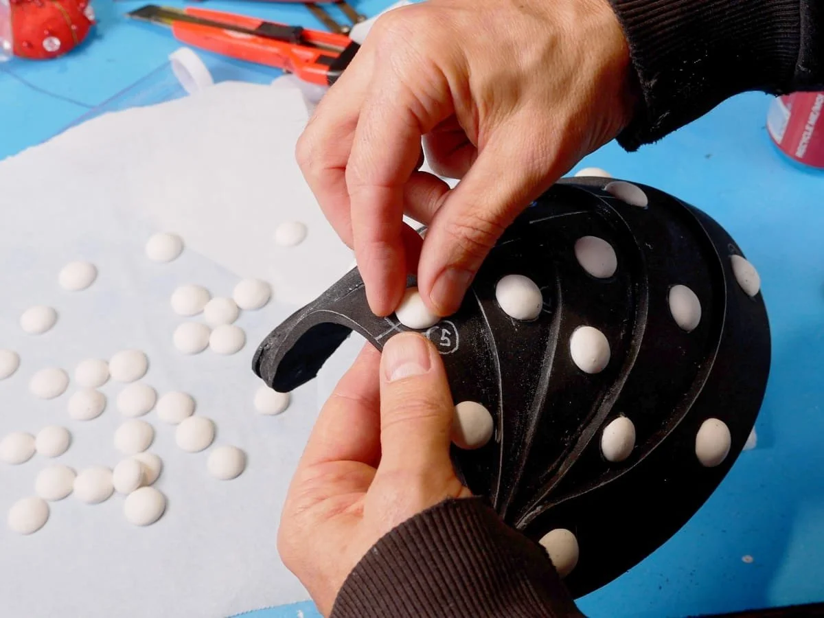 applying rivets to the pauldron