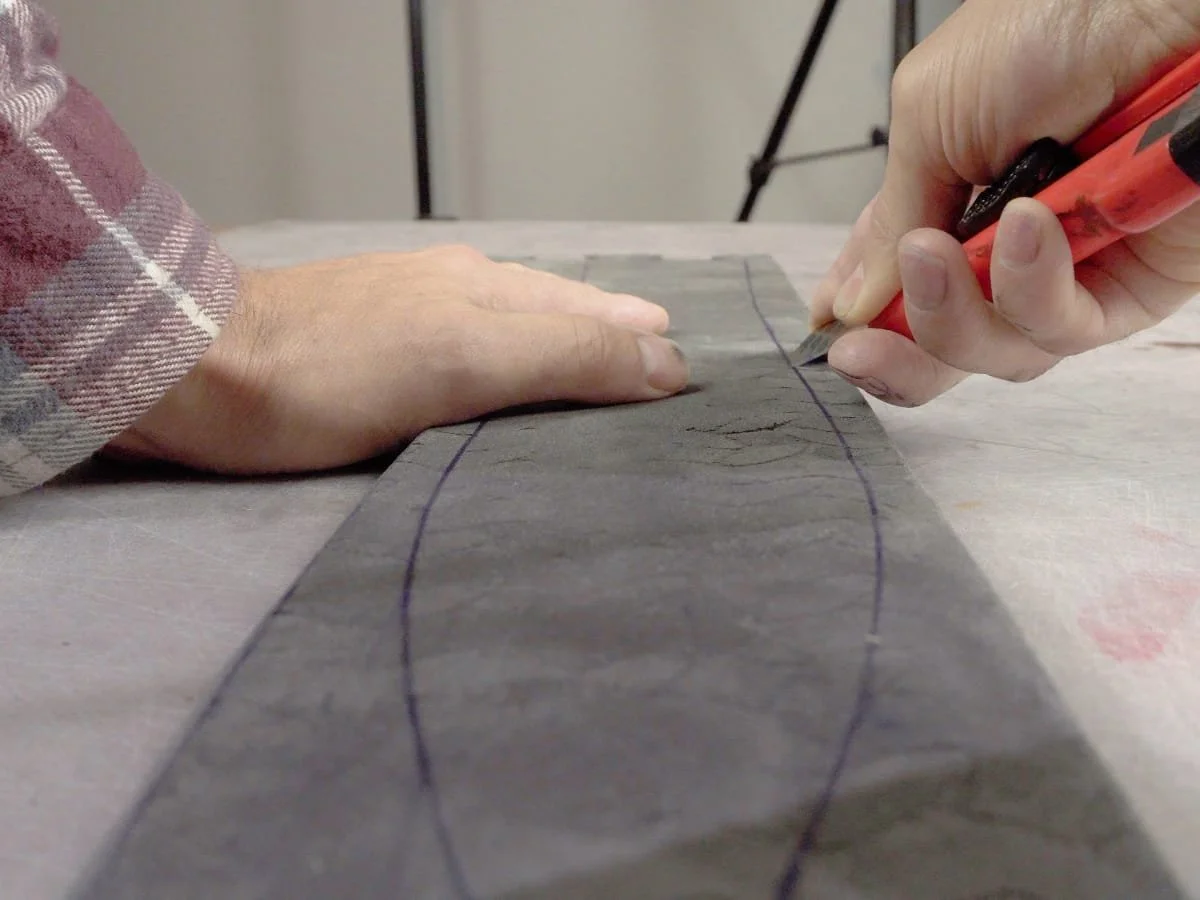 showing the angle of the knife as it cuts out the sword