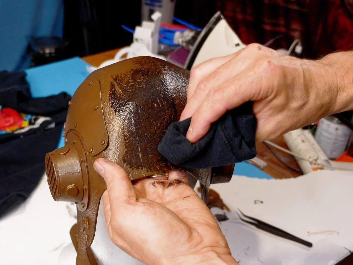 rubbing black paint over the foam to give a fake leather look
