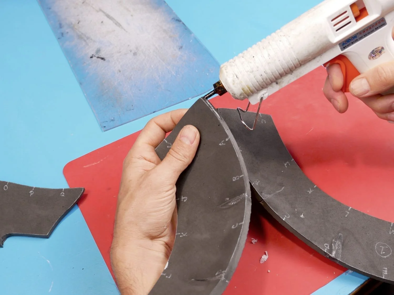 applying hot glue to one of the seams