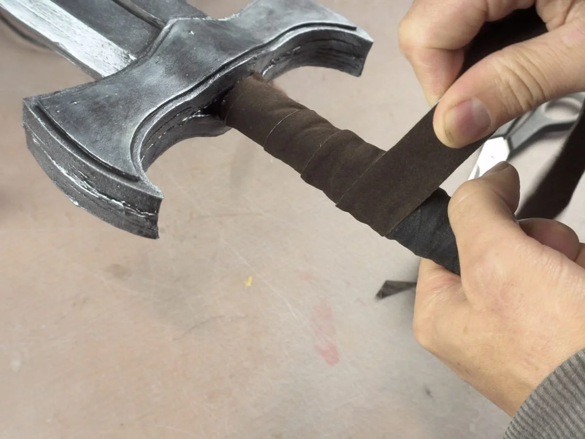 wrapping the handle with a leather strip
