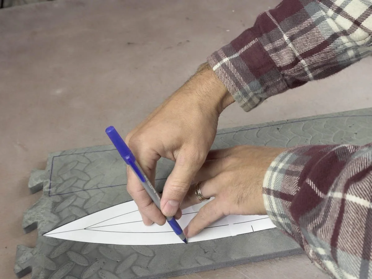 tracing the outline of the foam sword pattern onto a foam mat