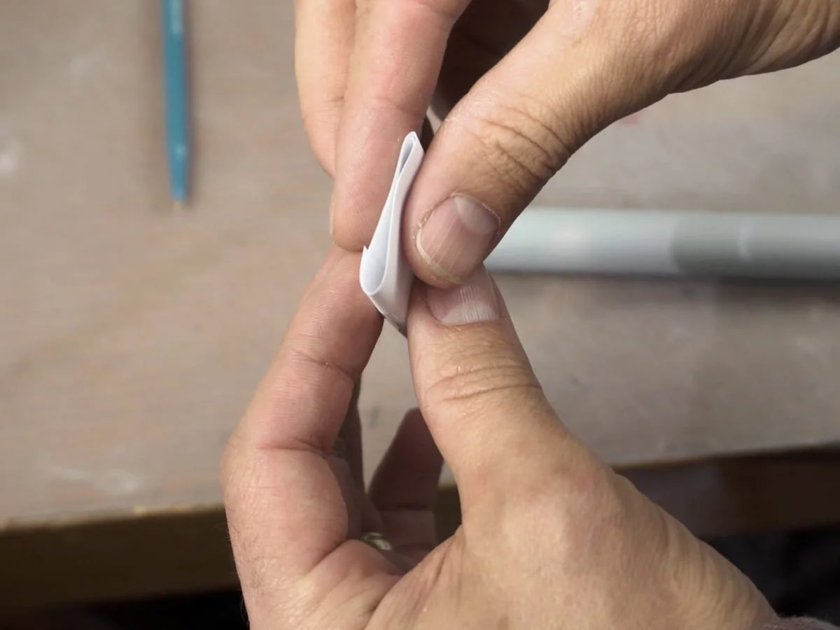 pinching paper tube flat for marking lines on the PVC