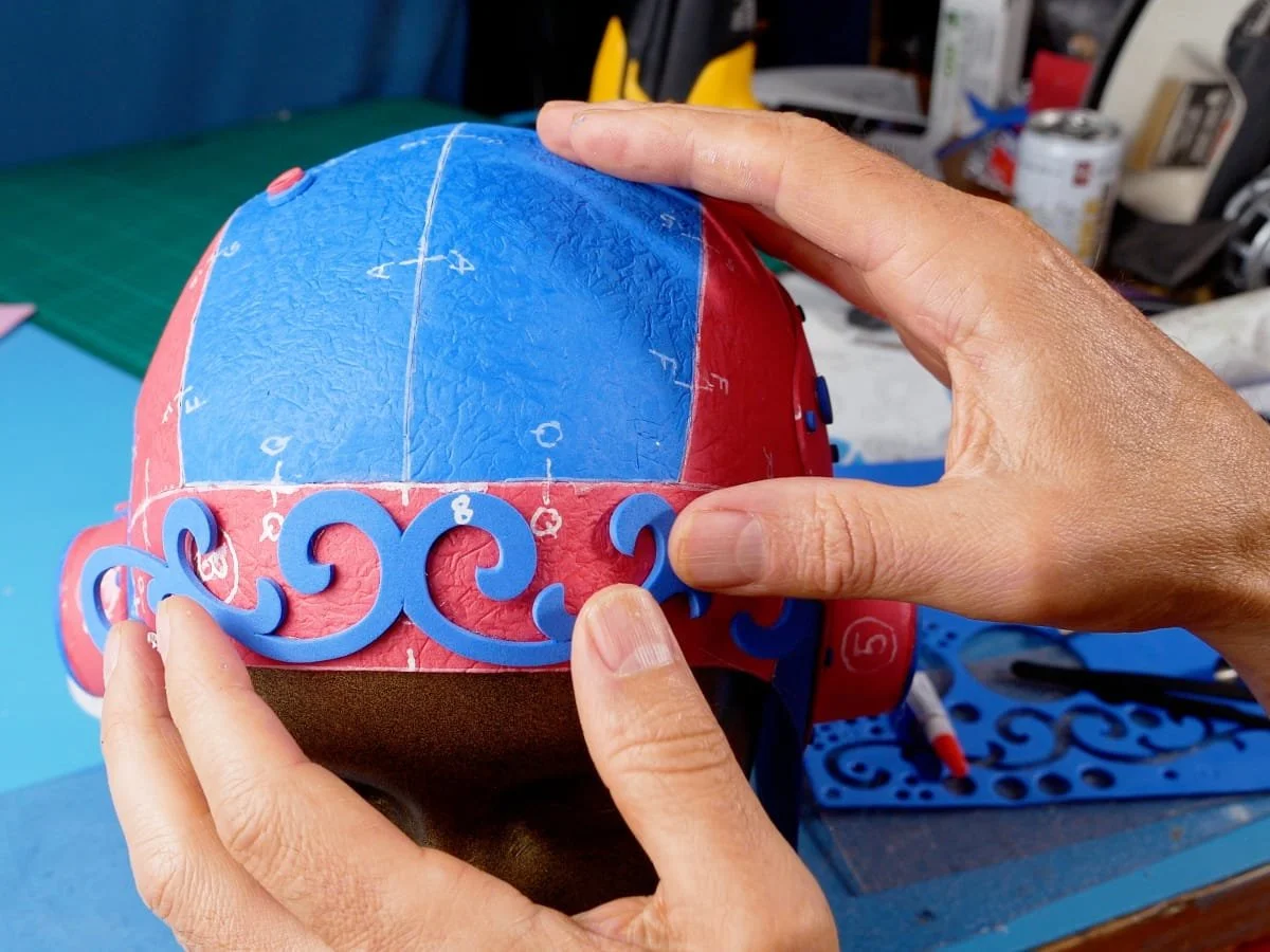 adding a swirly decorative piece to the front of the hat