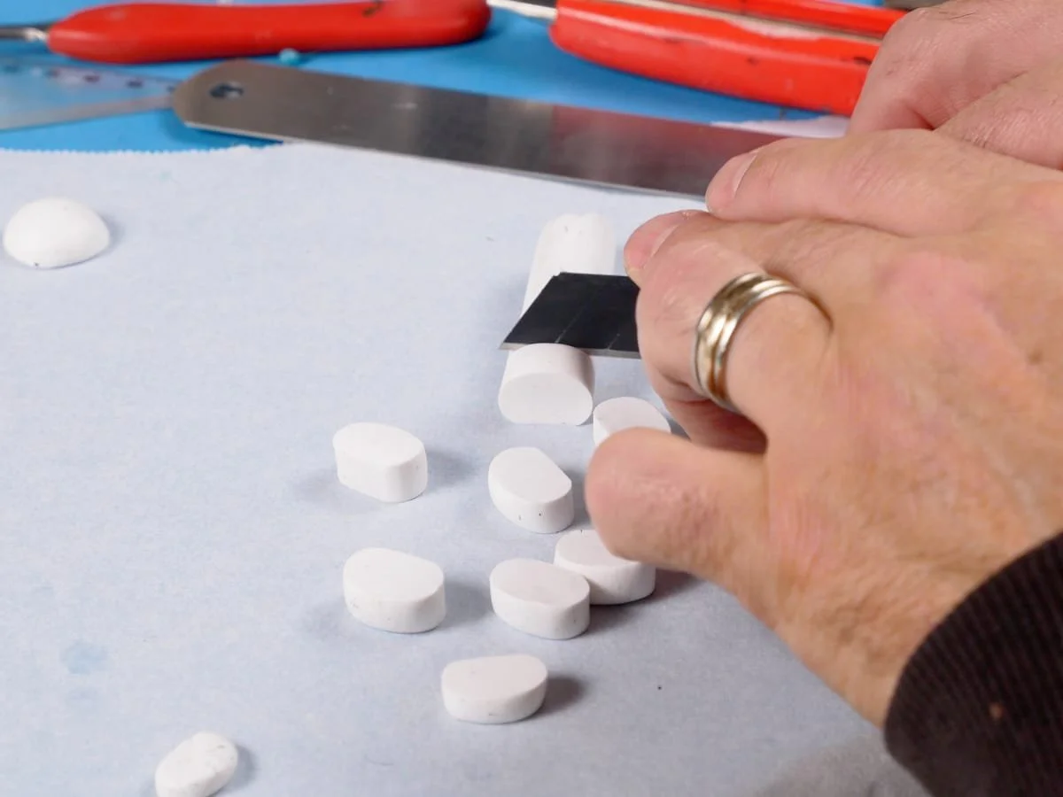 cutting a roll of polymer clay