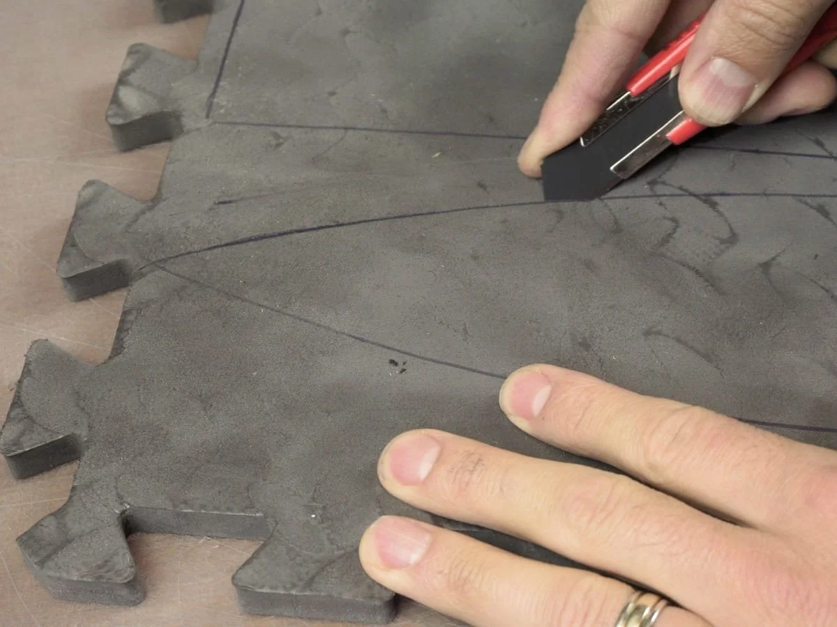 Cutting out the sword blade making sure to keep the knife at an angle