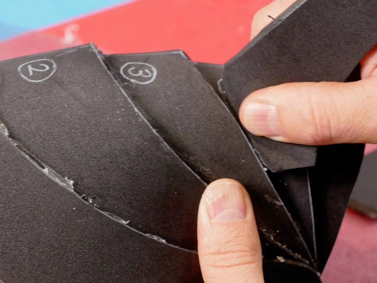 rubbing away the extra glue with a scrap of foam
