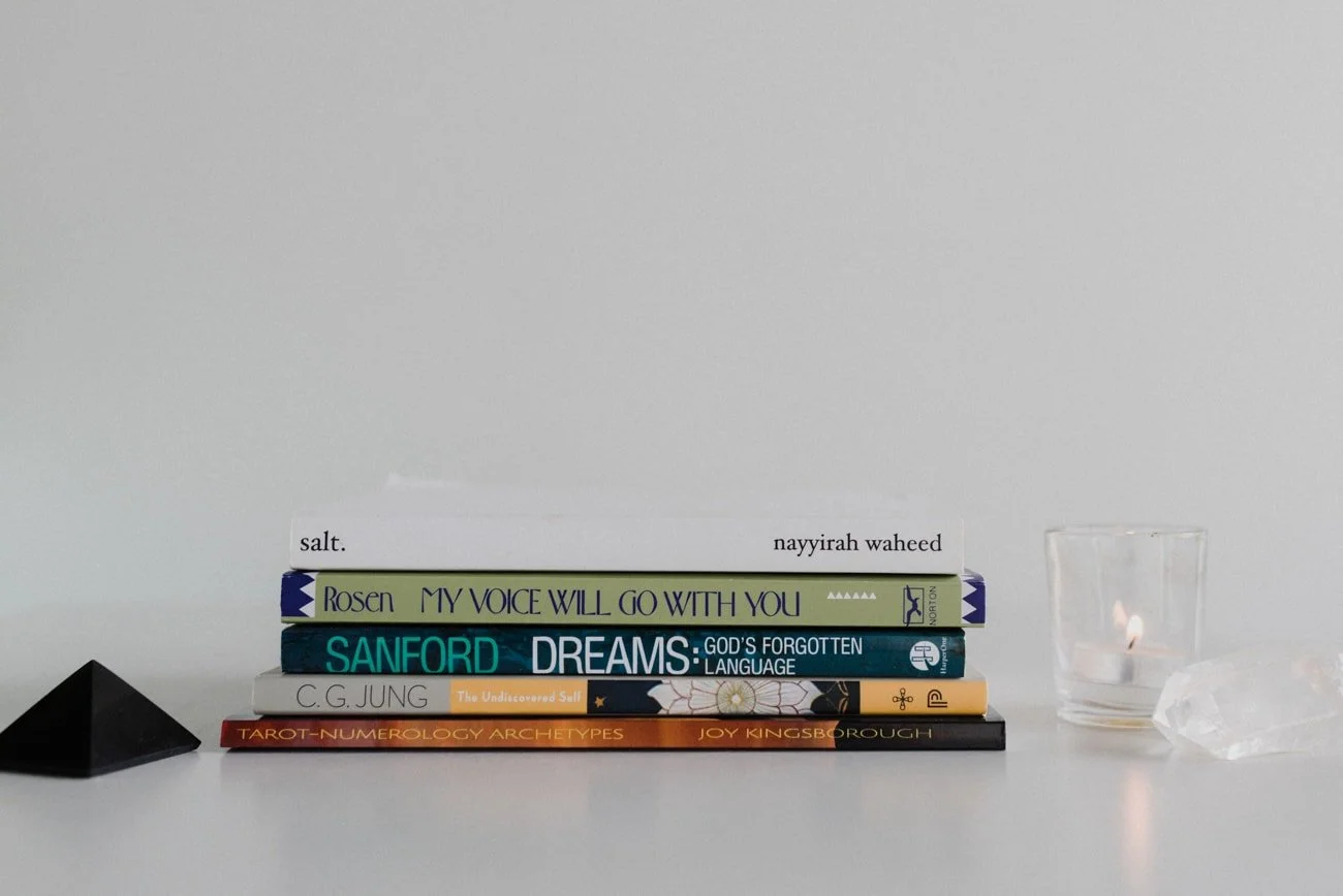 Five books about dreams and spiritual subjects on a table.