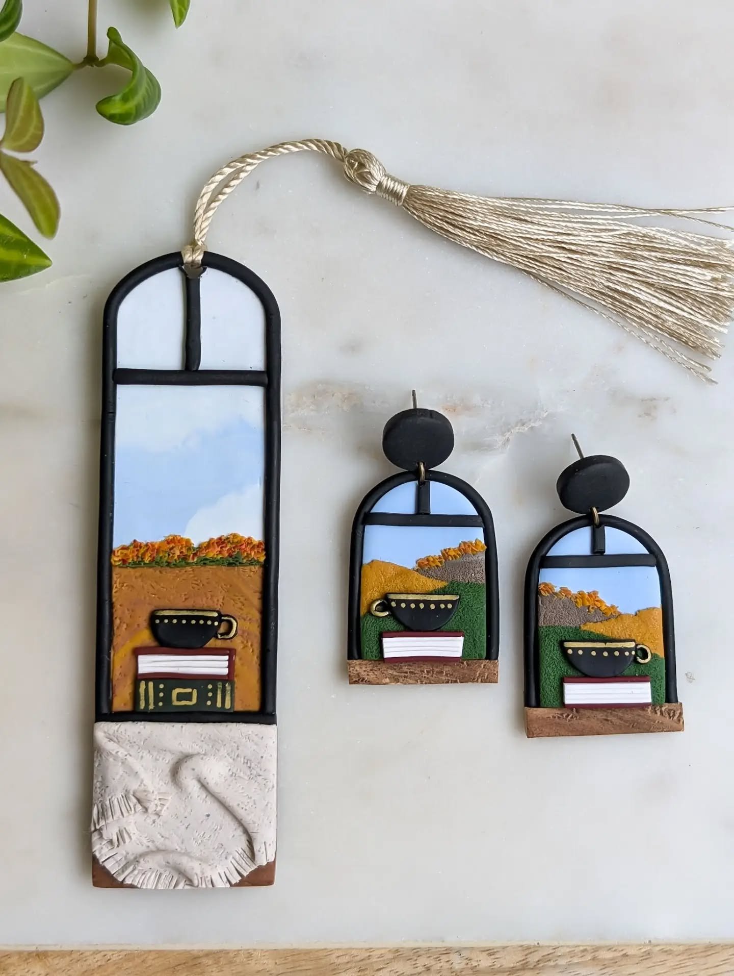 Keeping with the theme of earring designs turned bookmark: the cozy tea and books on an autumn windowsill. The bookmark features a knit blanket, ready for snuggling up on this cozy fall day.

Available on my website and at my coming markets... Only o