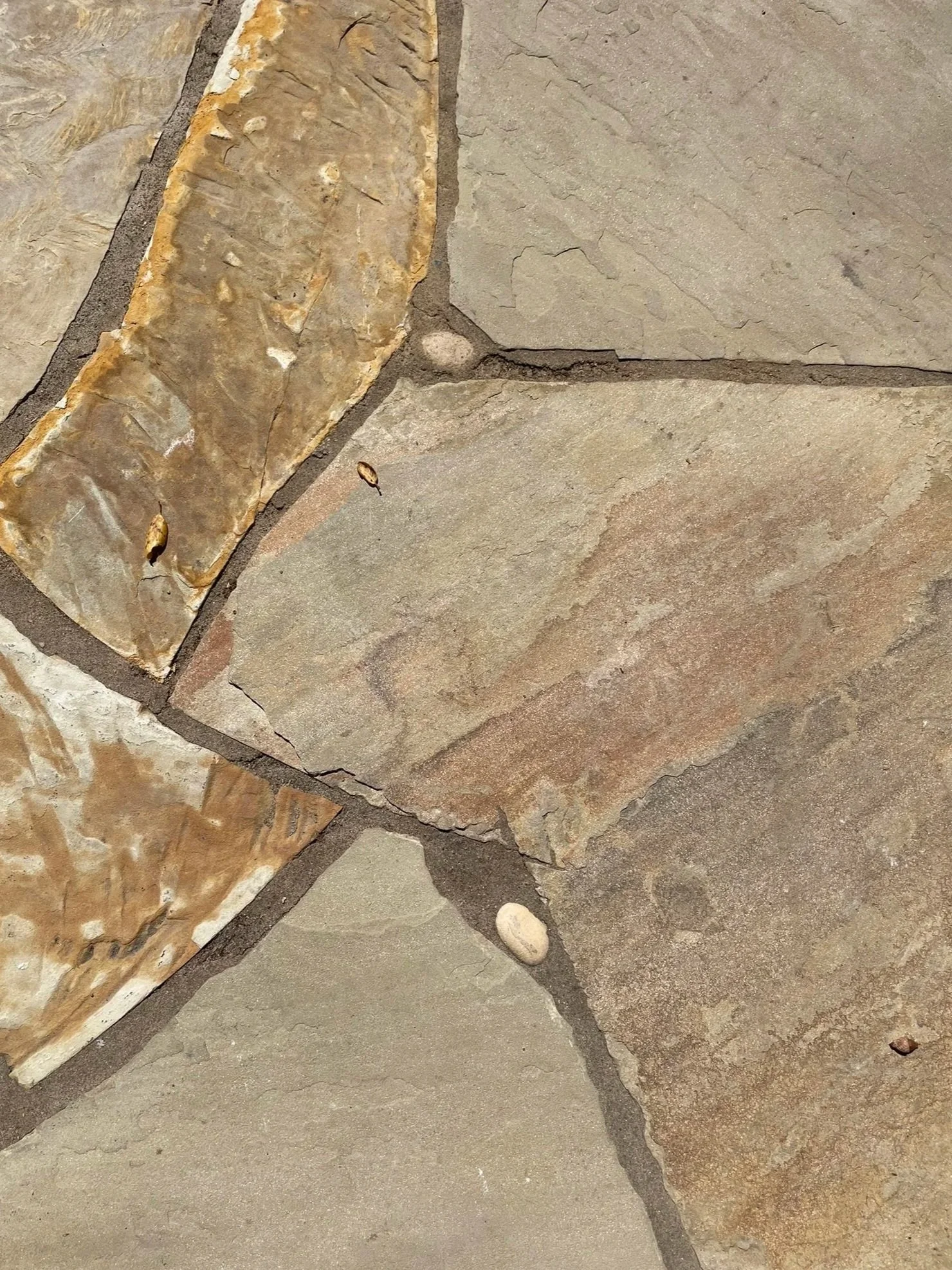 Artisanal flagstone patio featuring river pebbles in the joint lines, placed like jewels