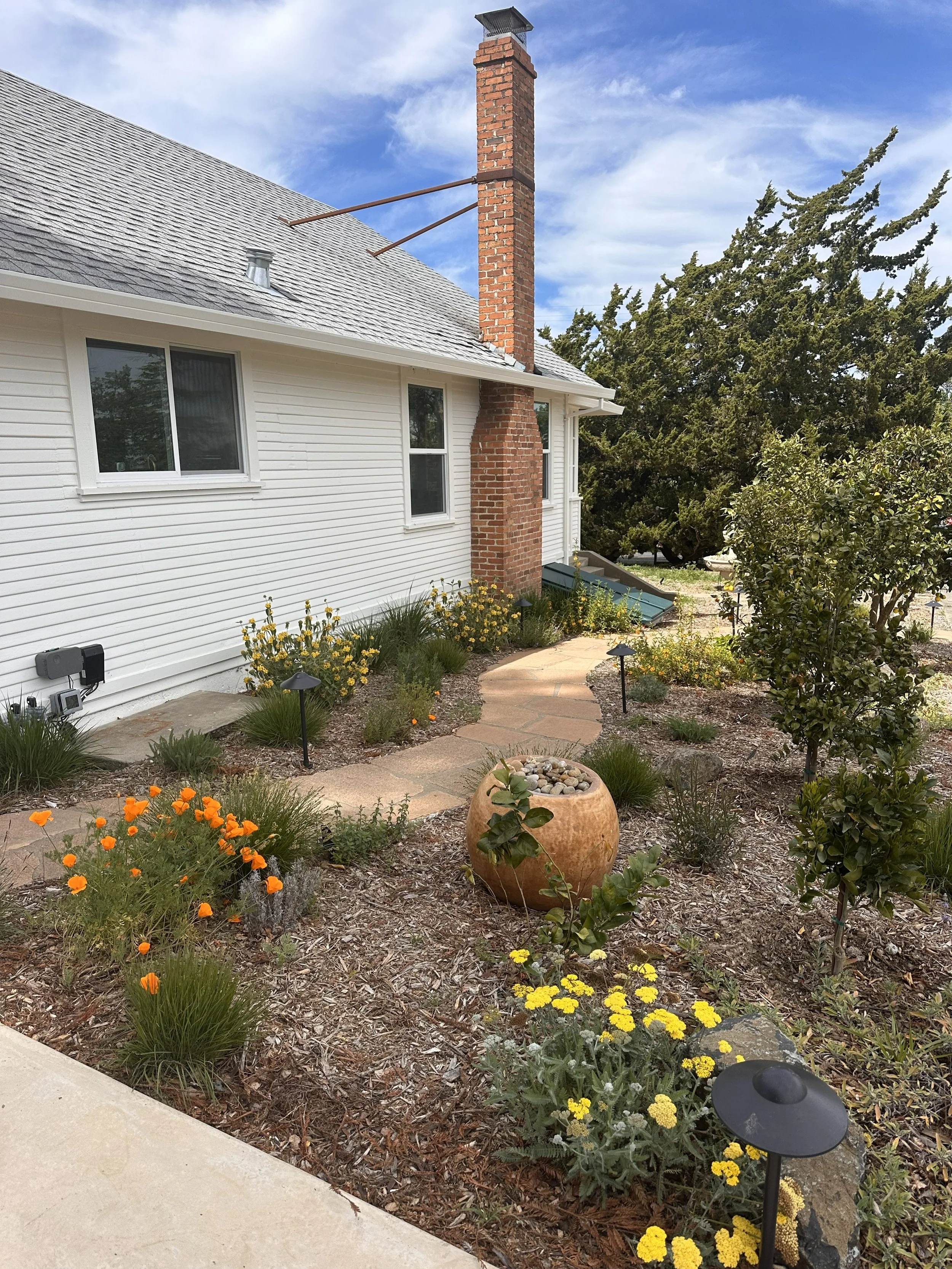 Urbanite pathway stained to match the red brick chimney