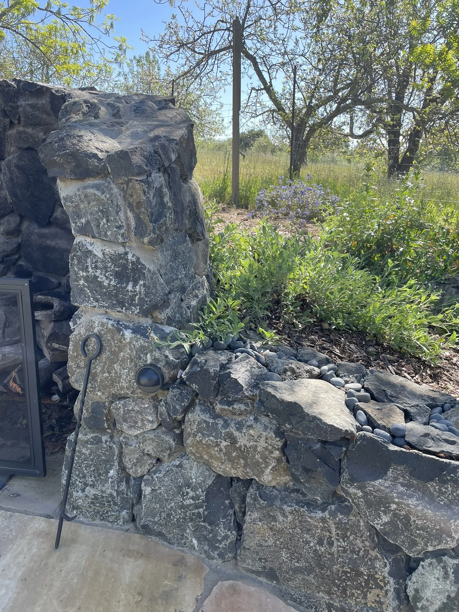 Stone hearth surrounds the outdoor patio