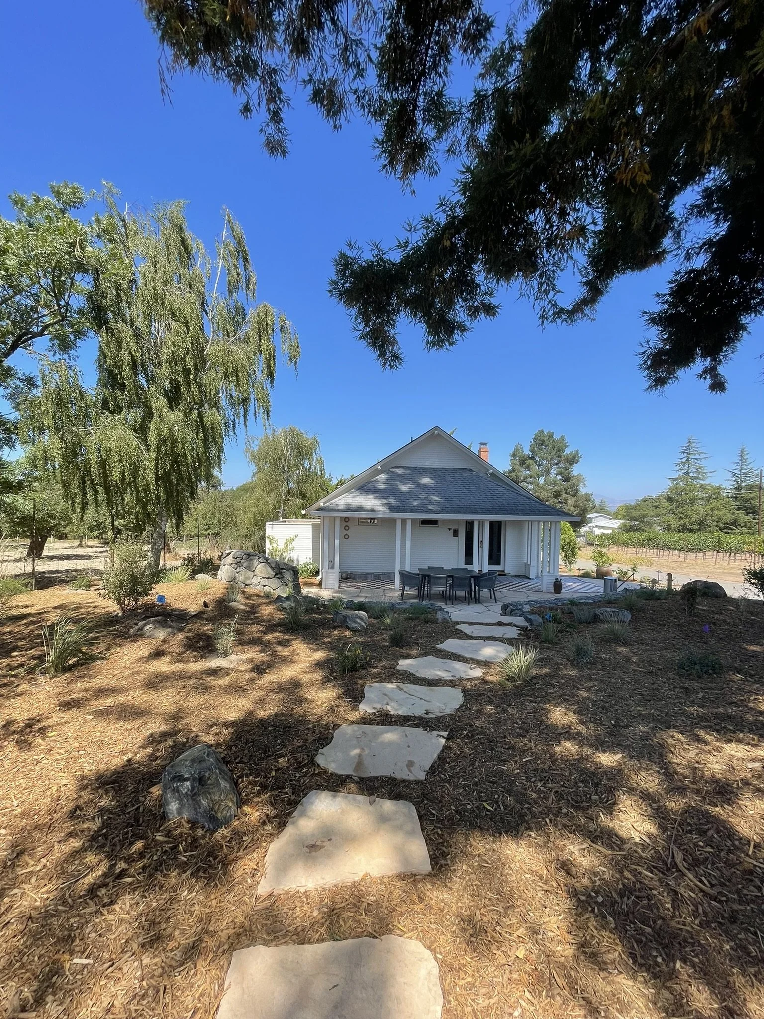 Pathway from the stone hearth, past the redwood trees, to the veggie garden