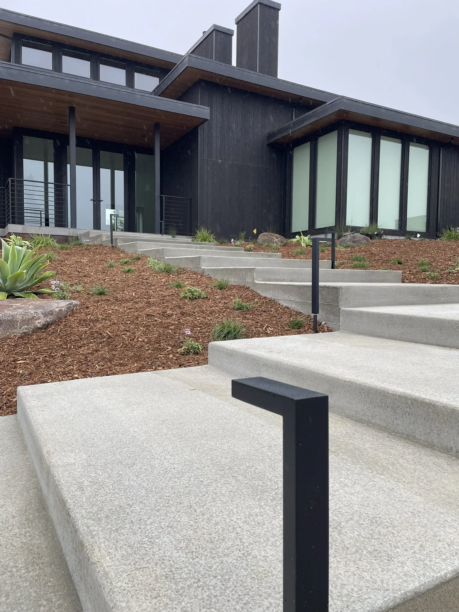 Close up photo of modern path lights used on the front entry staircase