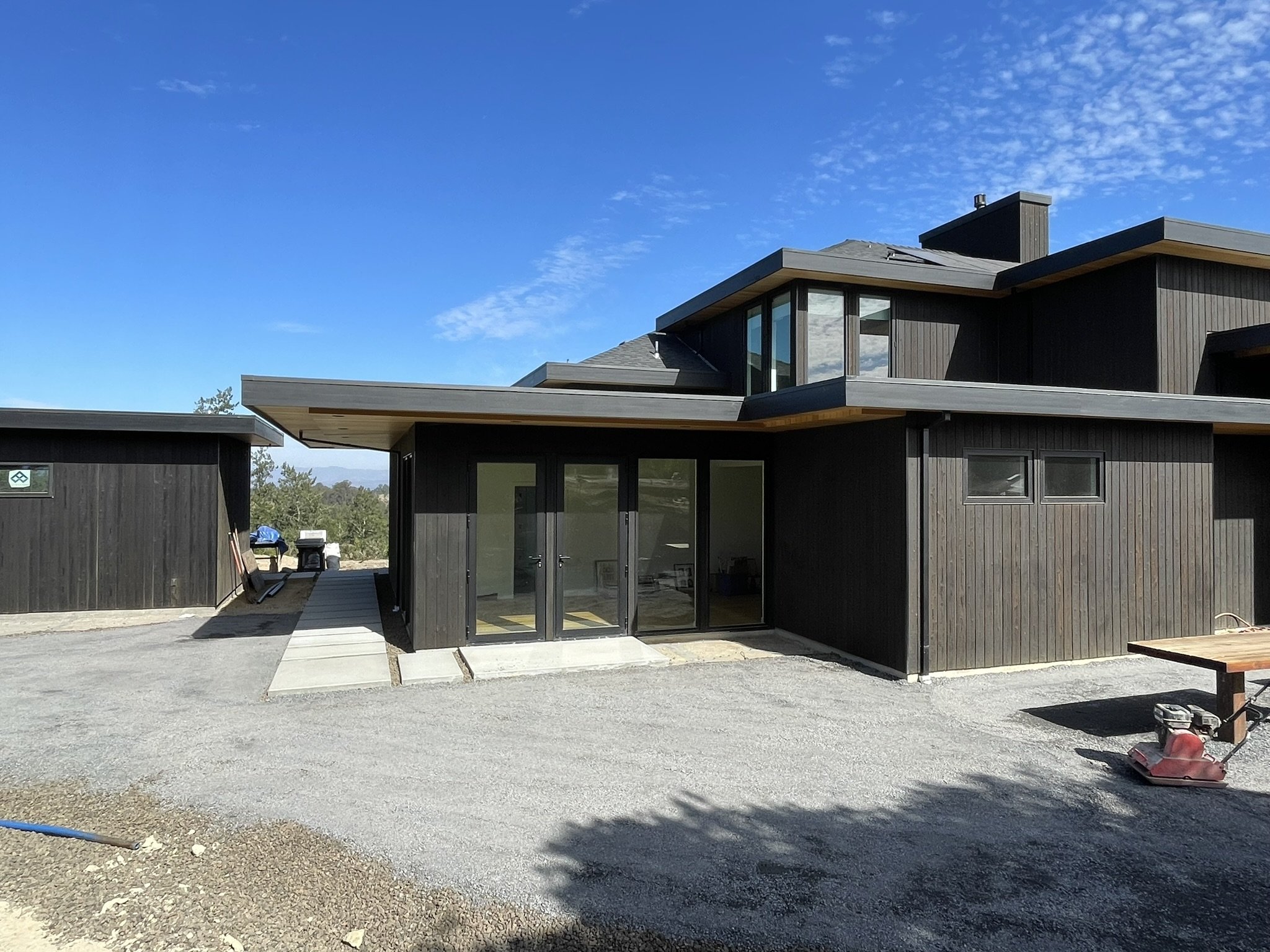 Cabana (left) and main home (right) before the mature olive tree is installed