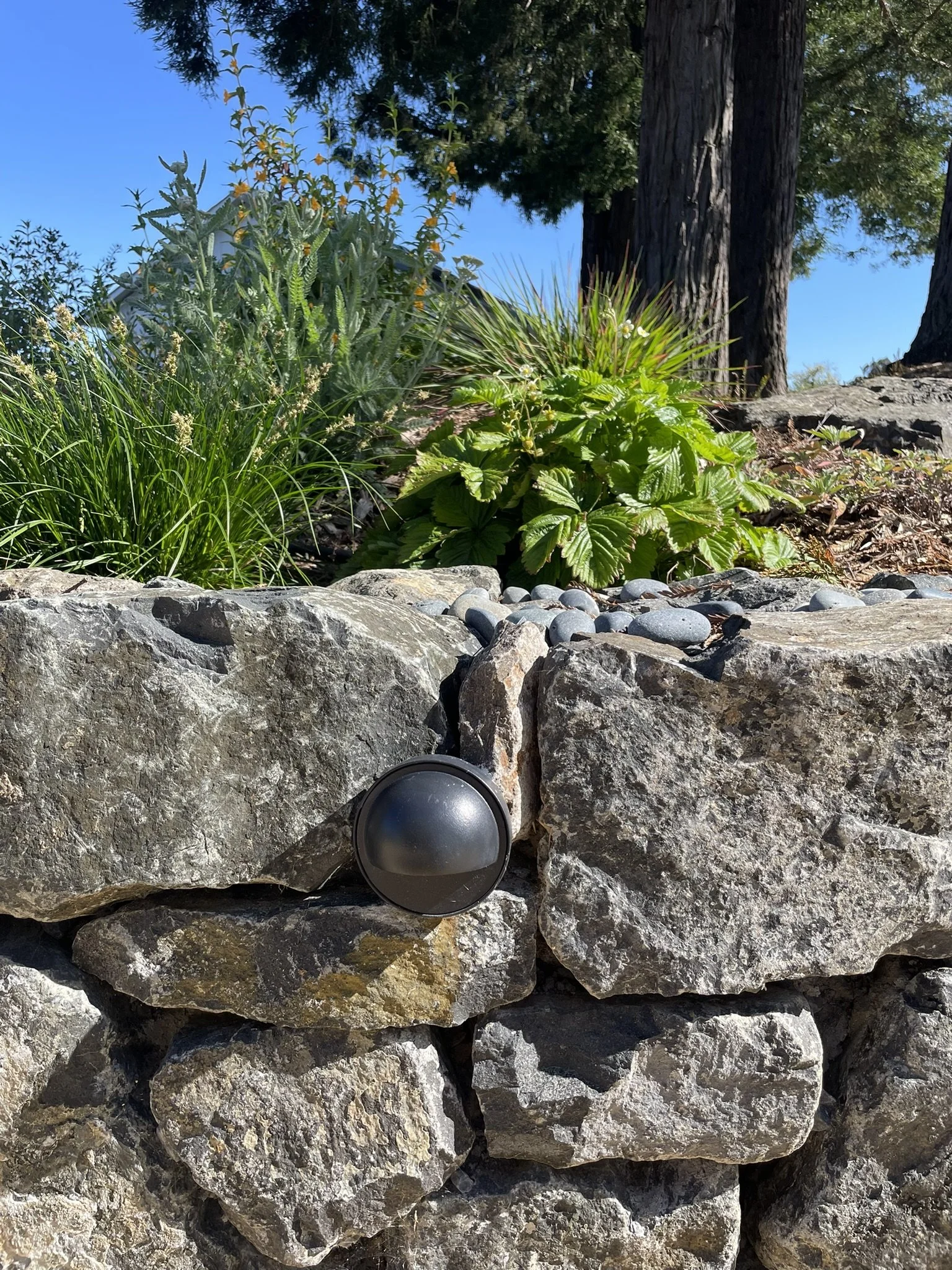 Dark-sky approved light fixtures set into the drystack stone wall