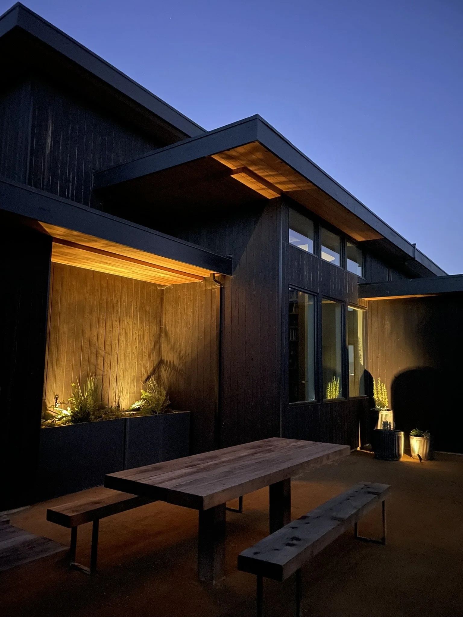 Low voltage lighting to highlight the angular architecture and container plantings