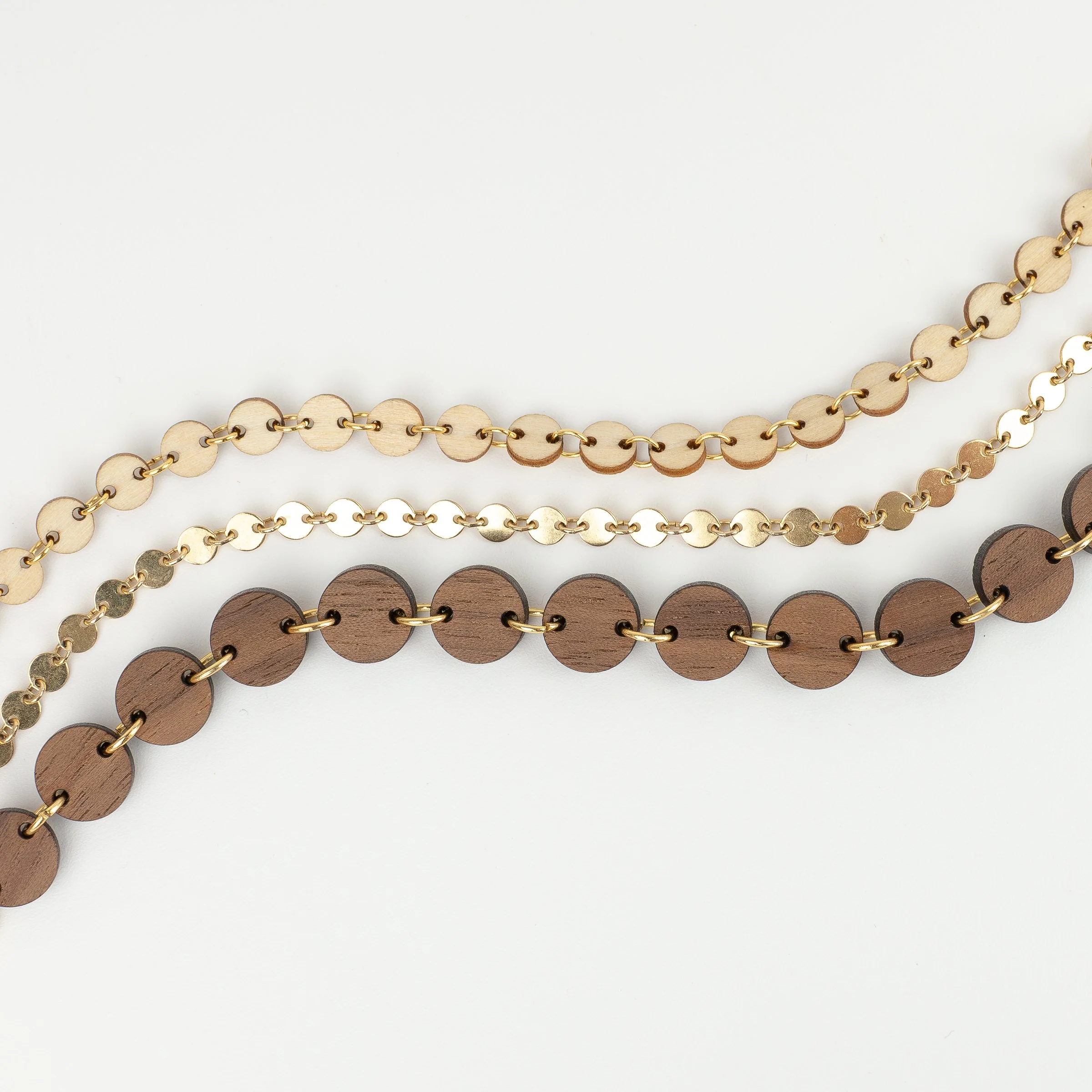 Overhead view of three handmade bracelets to show the size and color difference between each option.