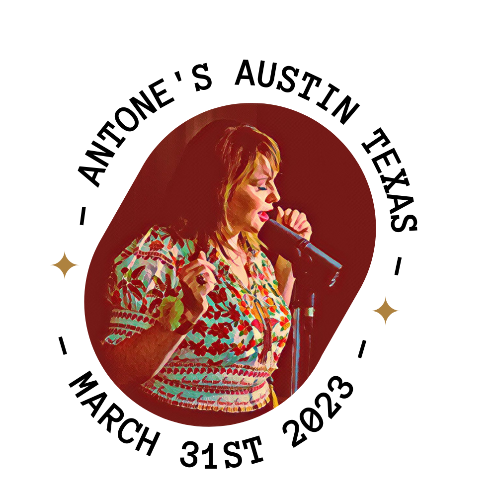 A woman singing into a microphone on stage.