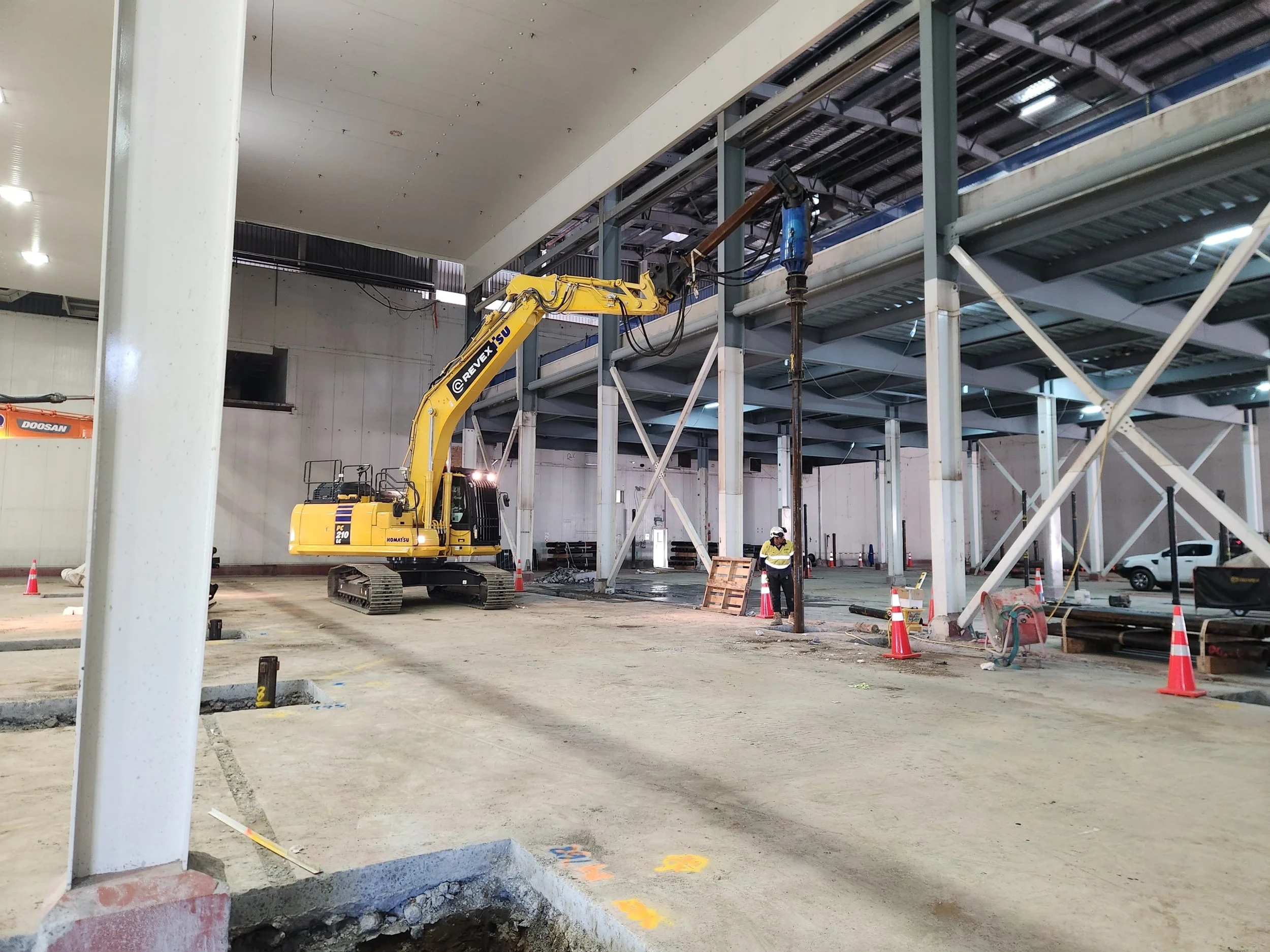 Installing screw piles inside an existing building