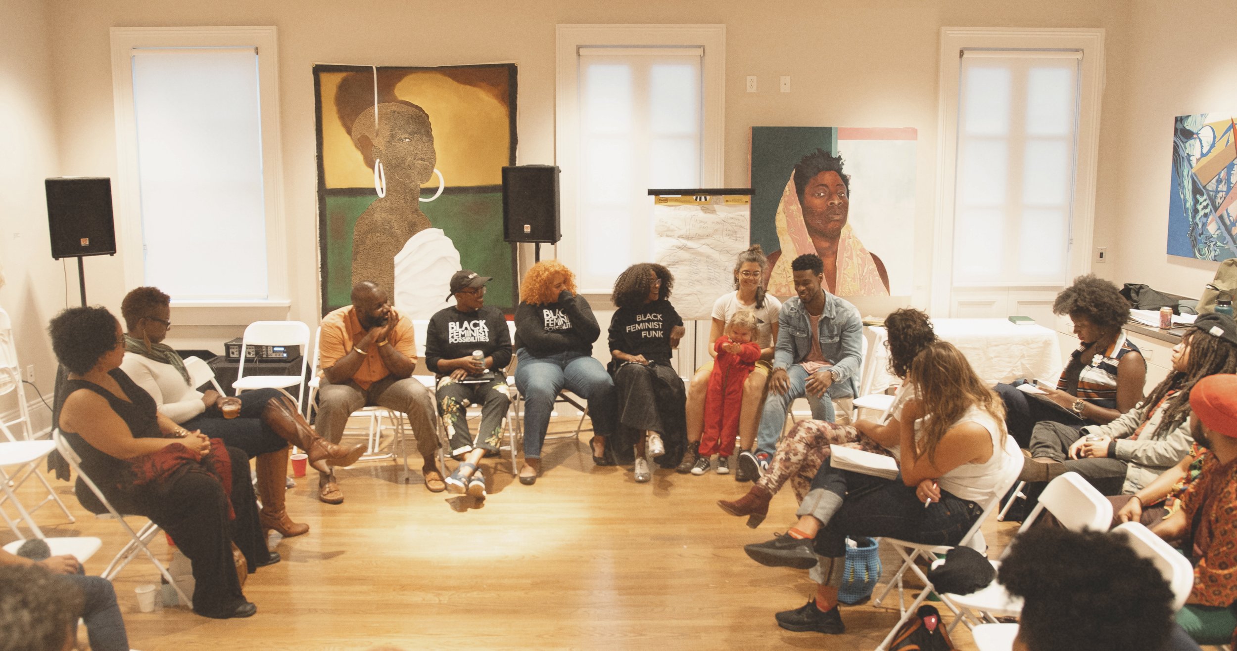 Willa sits in a circle of participants in a gathering