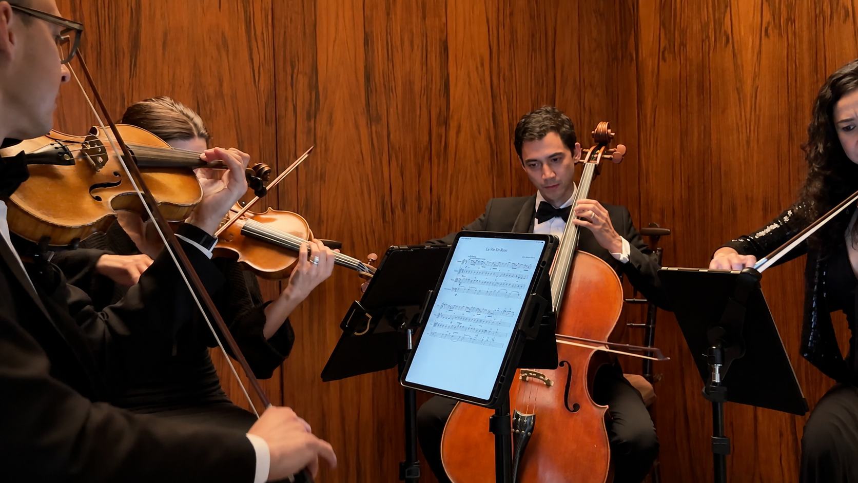 Professional string quartet performing during a corporate event in New York City.