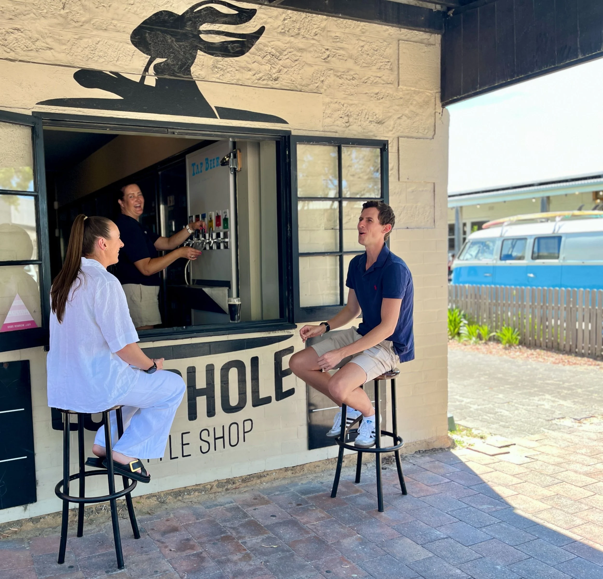 At the Loophole Brewing Co Robe taproom, locals enjoy craft beer served through the outdoor bar window — a relaxed, coastal setting on South Australia's Limestone Coast.