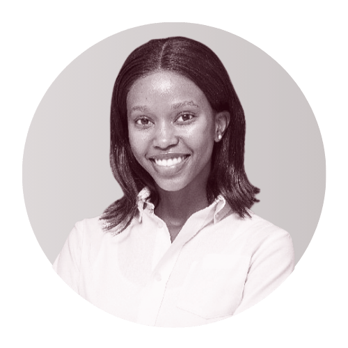 Black woman smiling and wearing a white shirt, with shoulder-length hair.