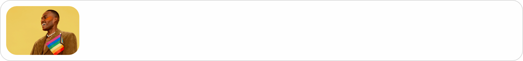 A person smiling and wearing a rainbow tie with a yellow background.