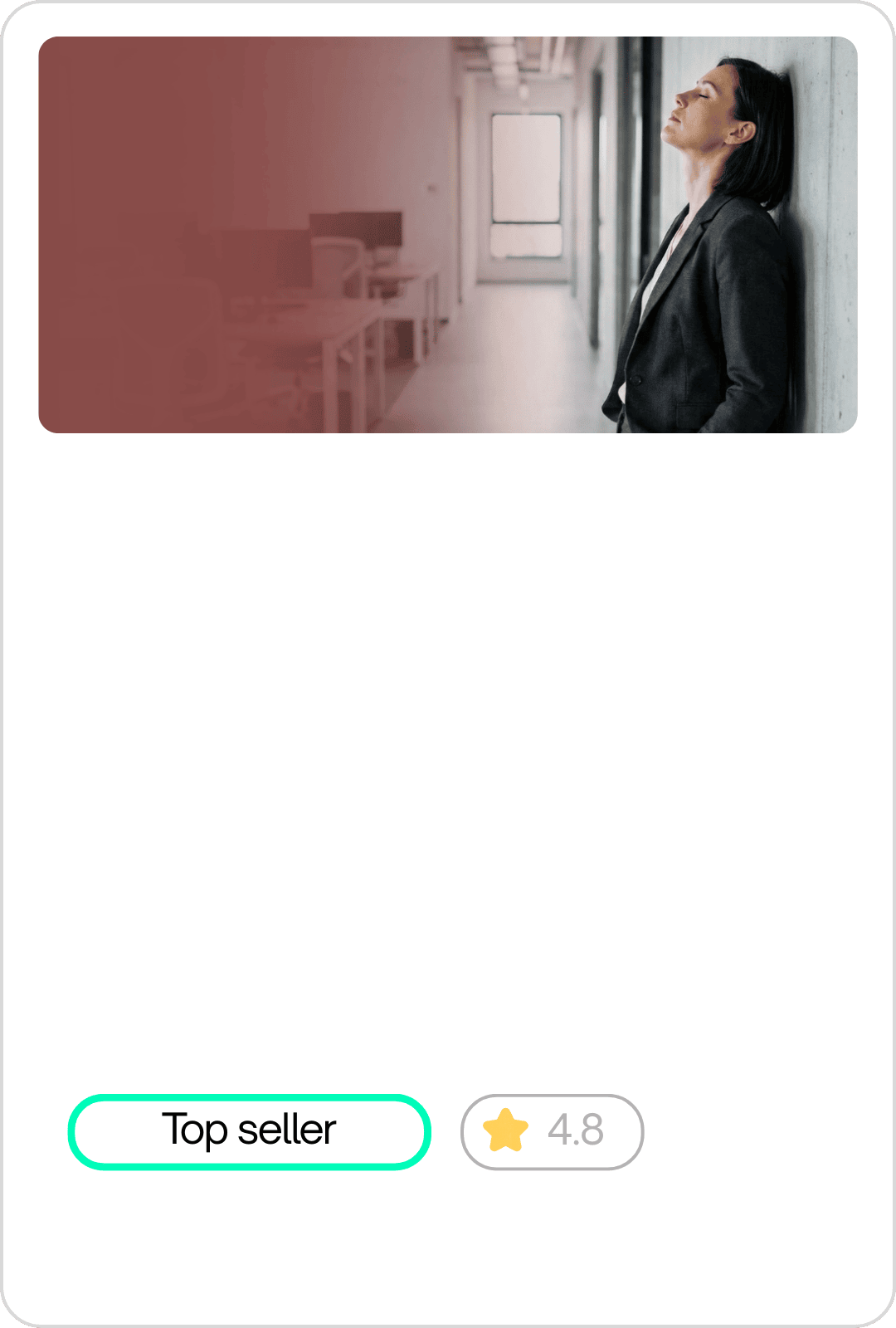 A woman in a business suit leaning against a wall with her eyes closed in a modern office corridor.