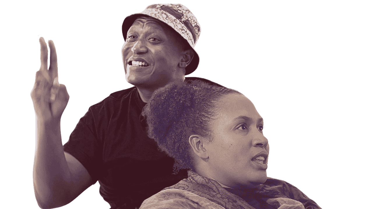 A man with a bucket hat and a woman with curly hair, both looking in different directions, with the man making a peace sign with his fingers.