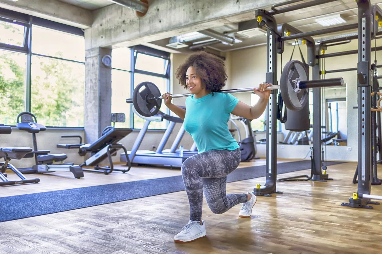 Smiling woman lifting weights