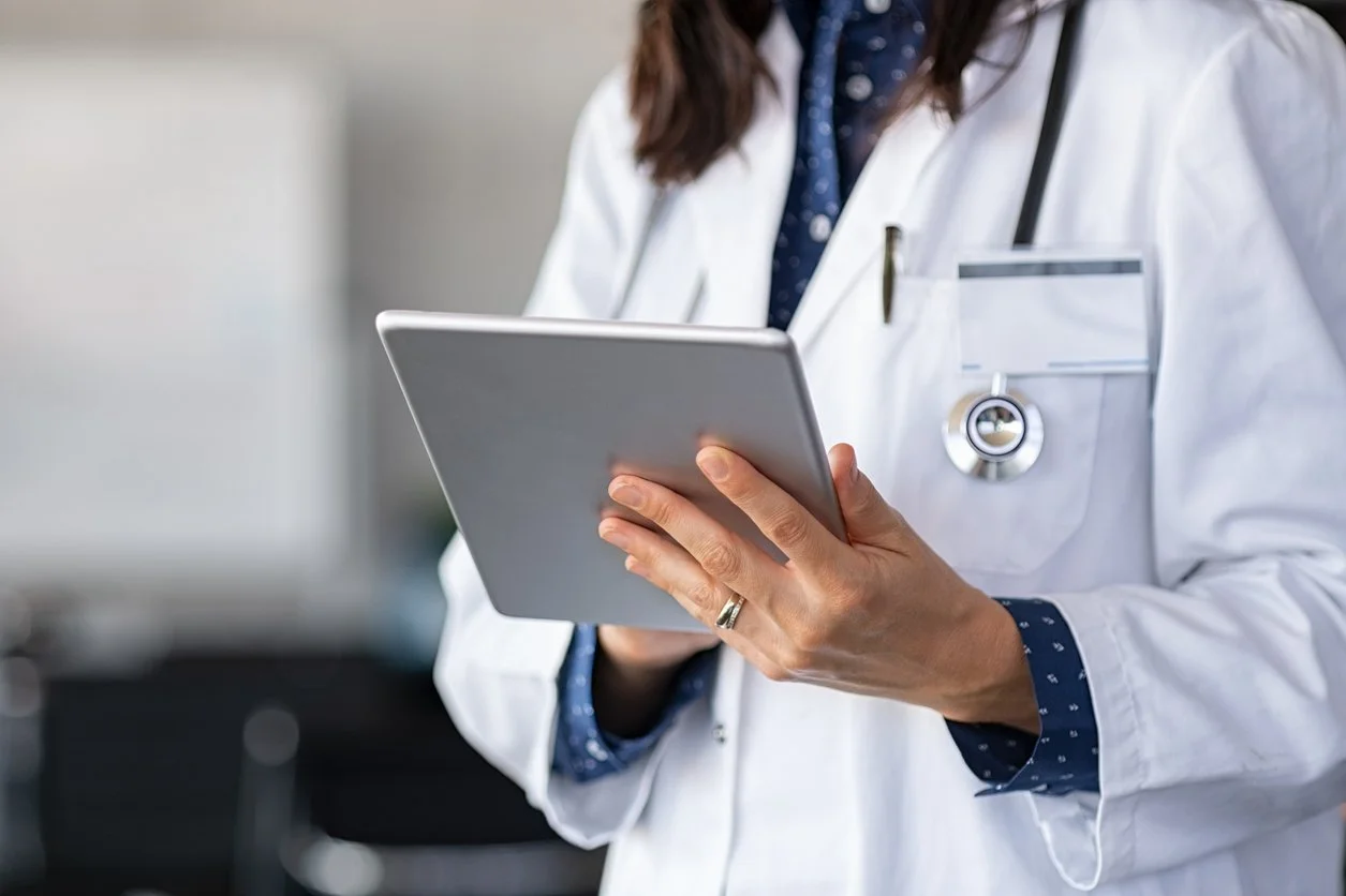A doctor holding a tablet.