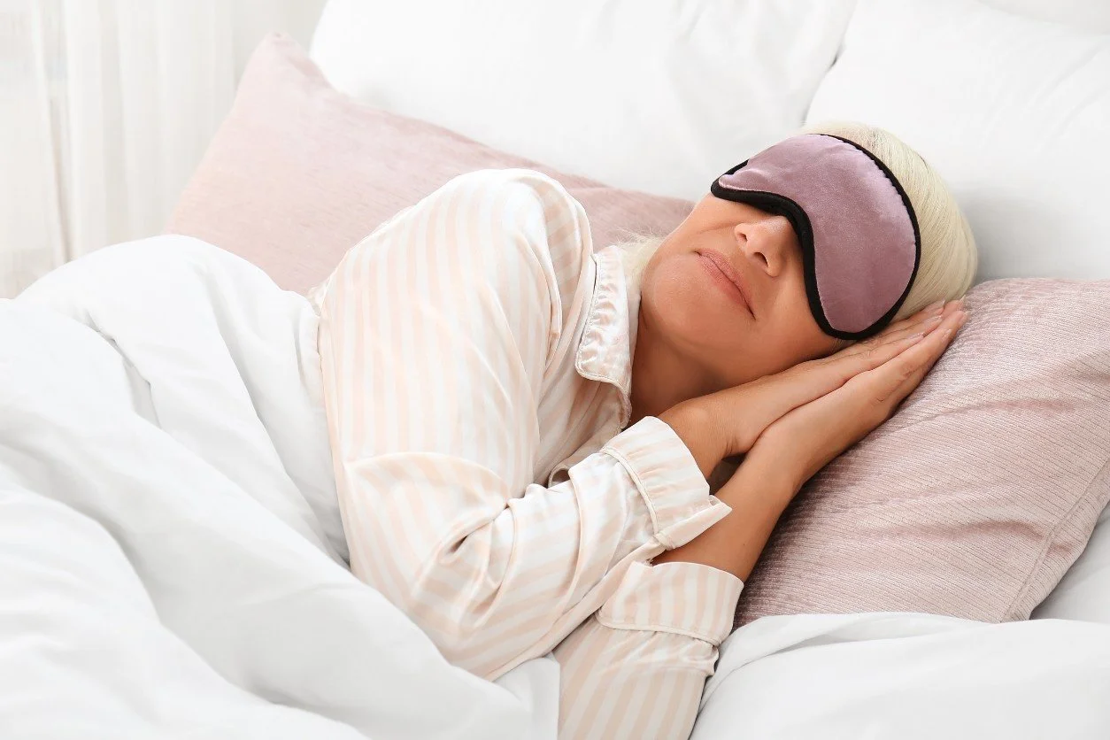 Perimenopause woman sleeping with an eye mask