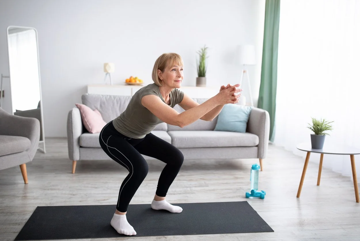 A woman doing squats in her living room