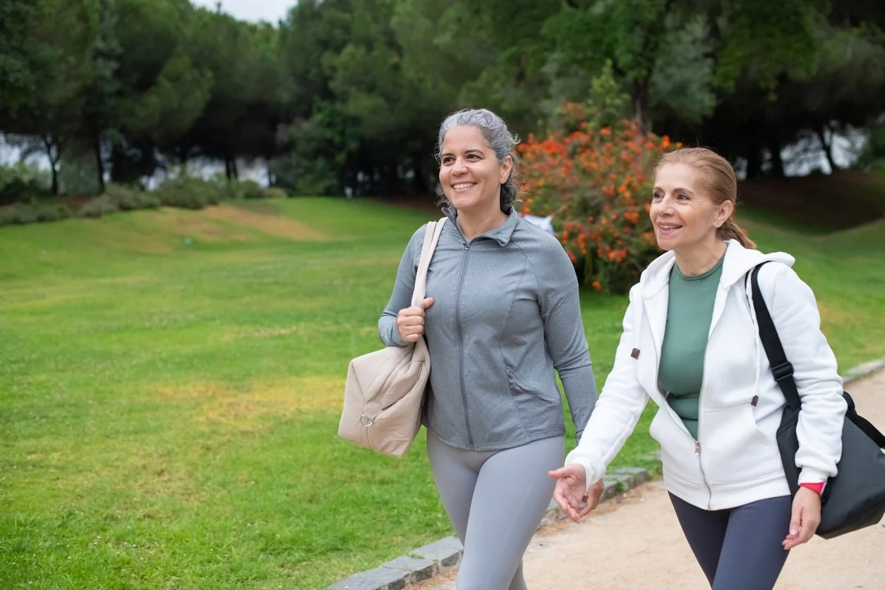Two smiling women walking together