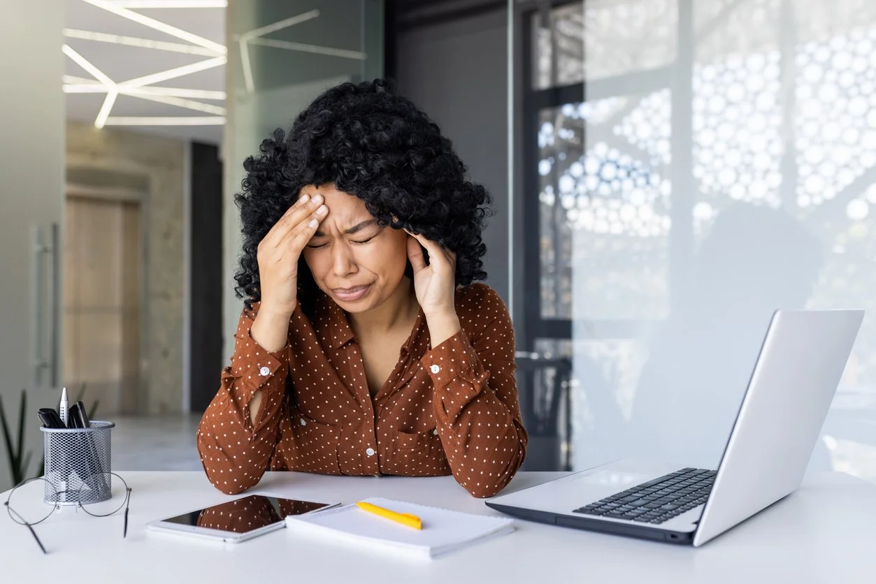 A woman experiencing a painful migraine