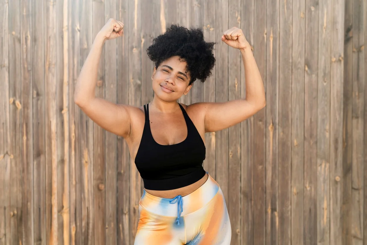 A woman flexing her arm muscles