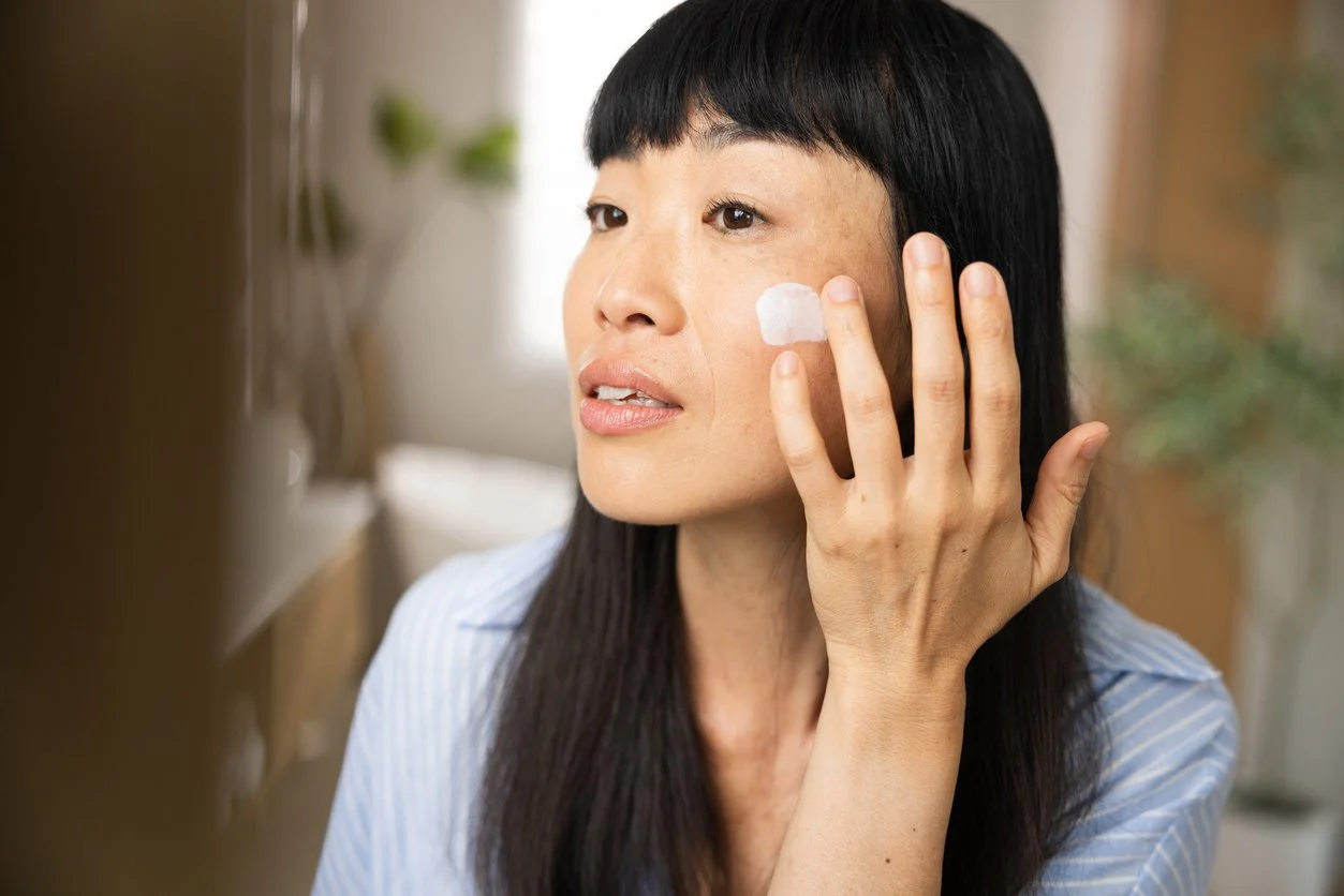 A woman applying her morning routine in bathroom